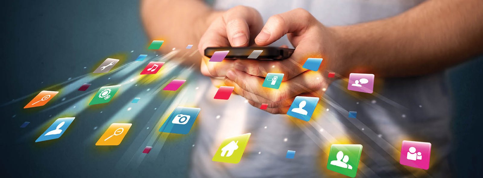 Man holding smartphone with technology application icons comming out