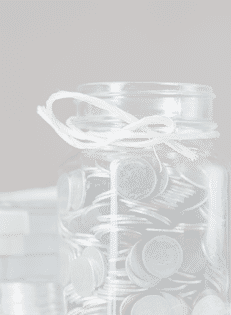 Bottles of cash with coins in saving money concept