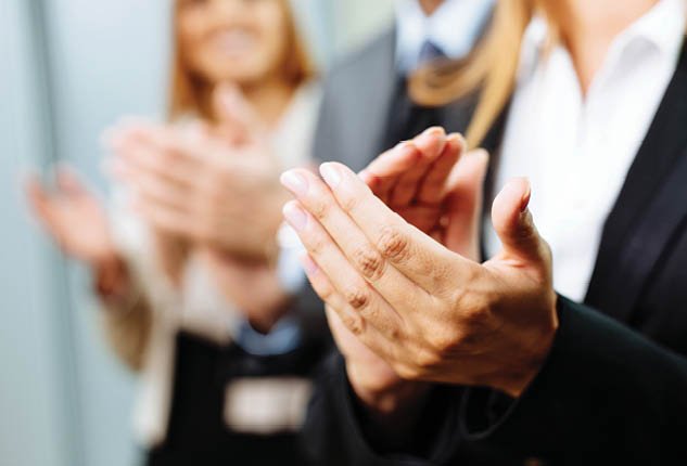 Close-up of business people clapping hands. Business seminar concept