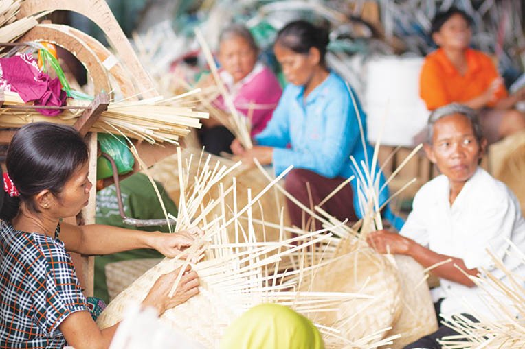 Yogya, Indonesia-October 2016: A group of female workers produce handicrafts in a workshop in Yogya. Small and medium enterprises (SME), so called UMKM, is one main foundations of our economy.